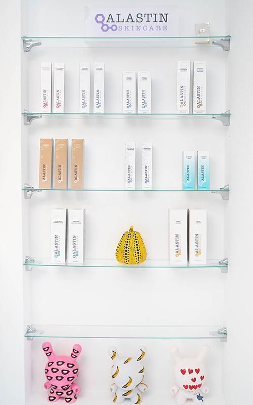 Skincare products displayed on glass shelves.