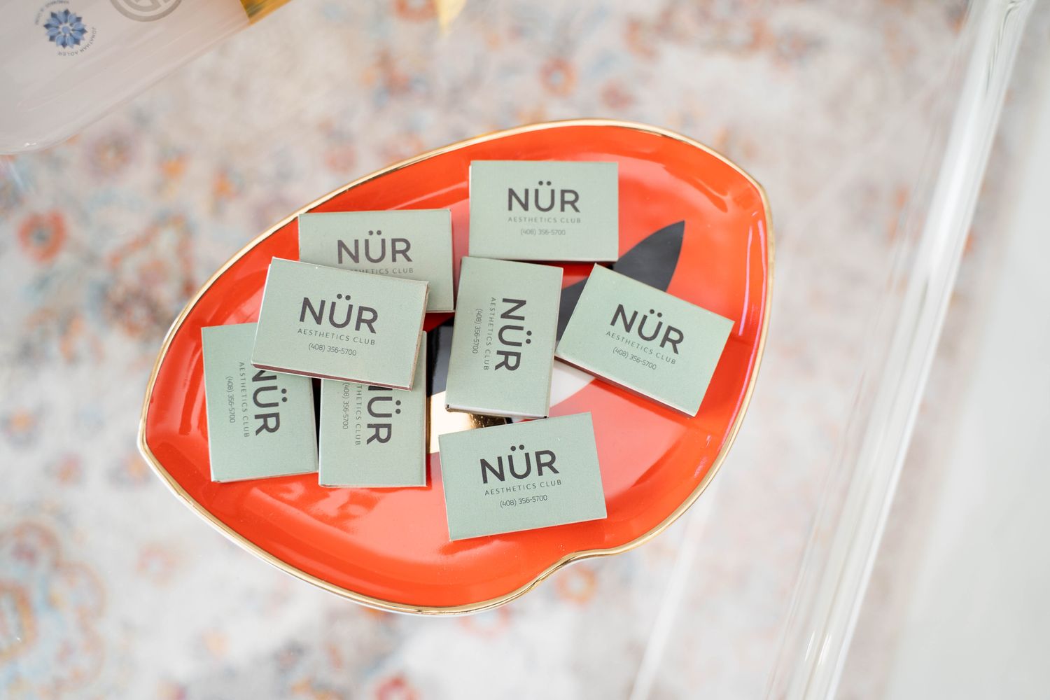 Business cards in an orange decorative dish.