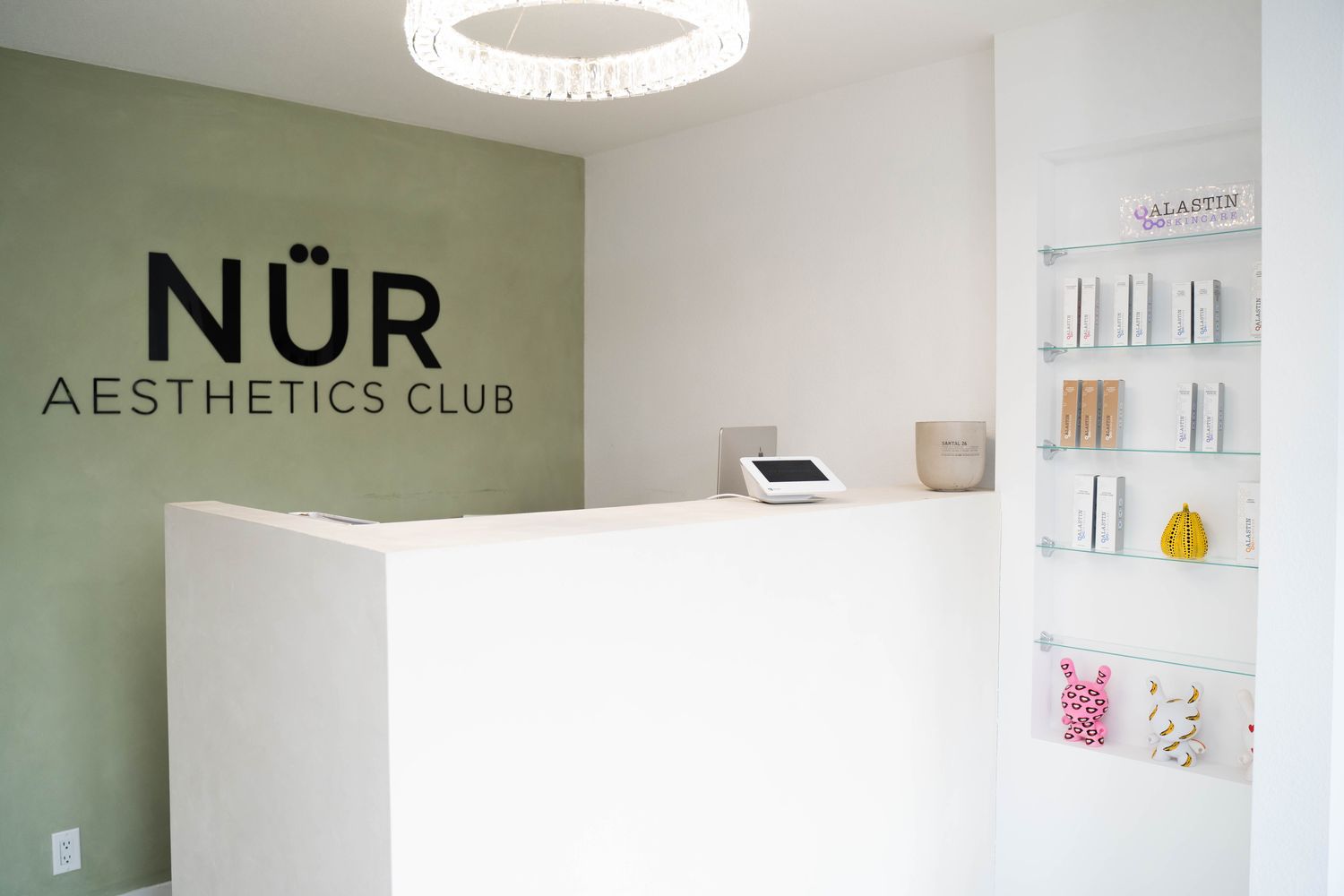 Modern aesthetics club reception area with products.