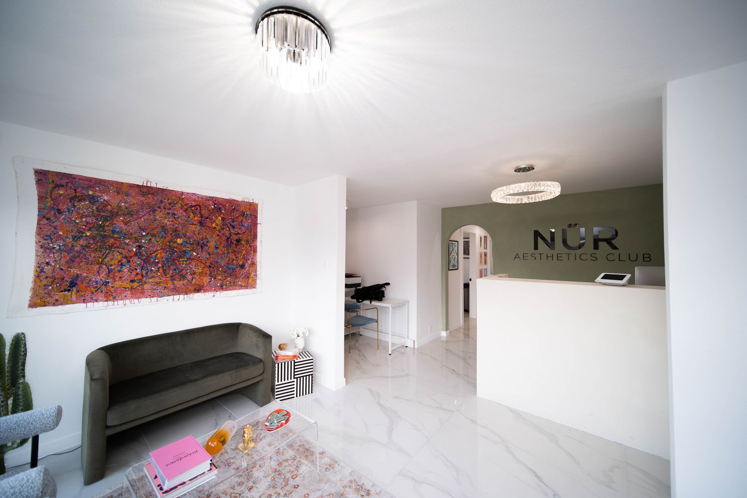 Modern aesthetics clinic reception area with art.