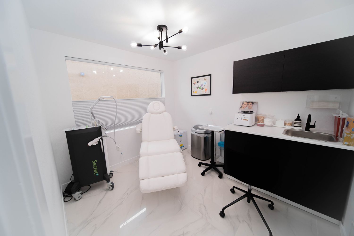 Modern skincare treatment room with white furnishings.