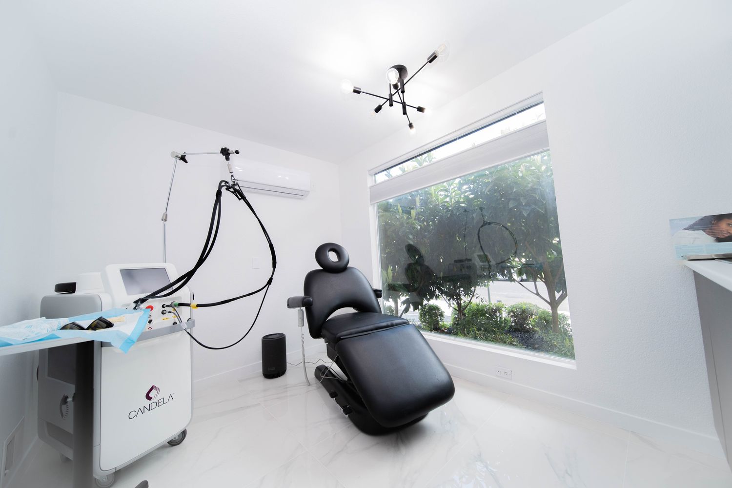 Modern aesthetic treatment room with equipment.
