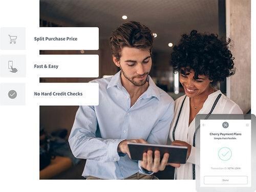 Couple discussing payment options on a tablet.