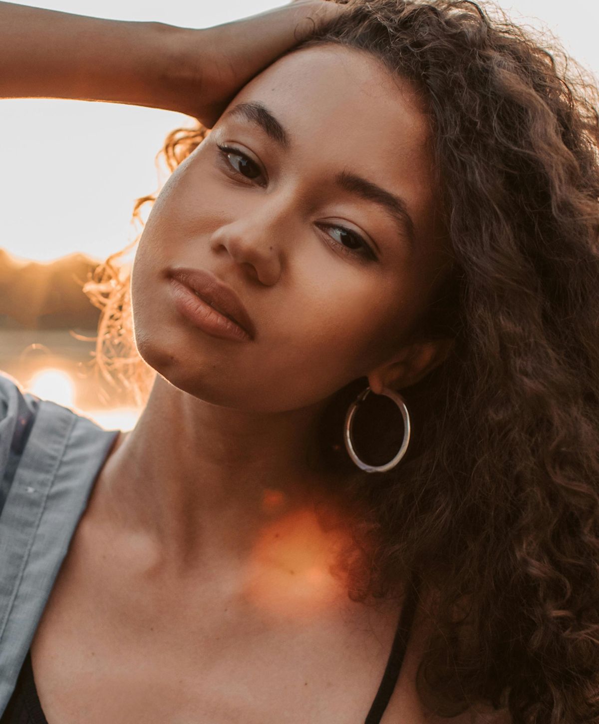 Young Santa Clara dermal fillers model with long brown hair and blue eyes.