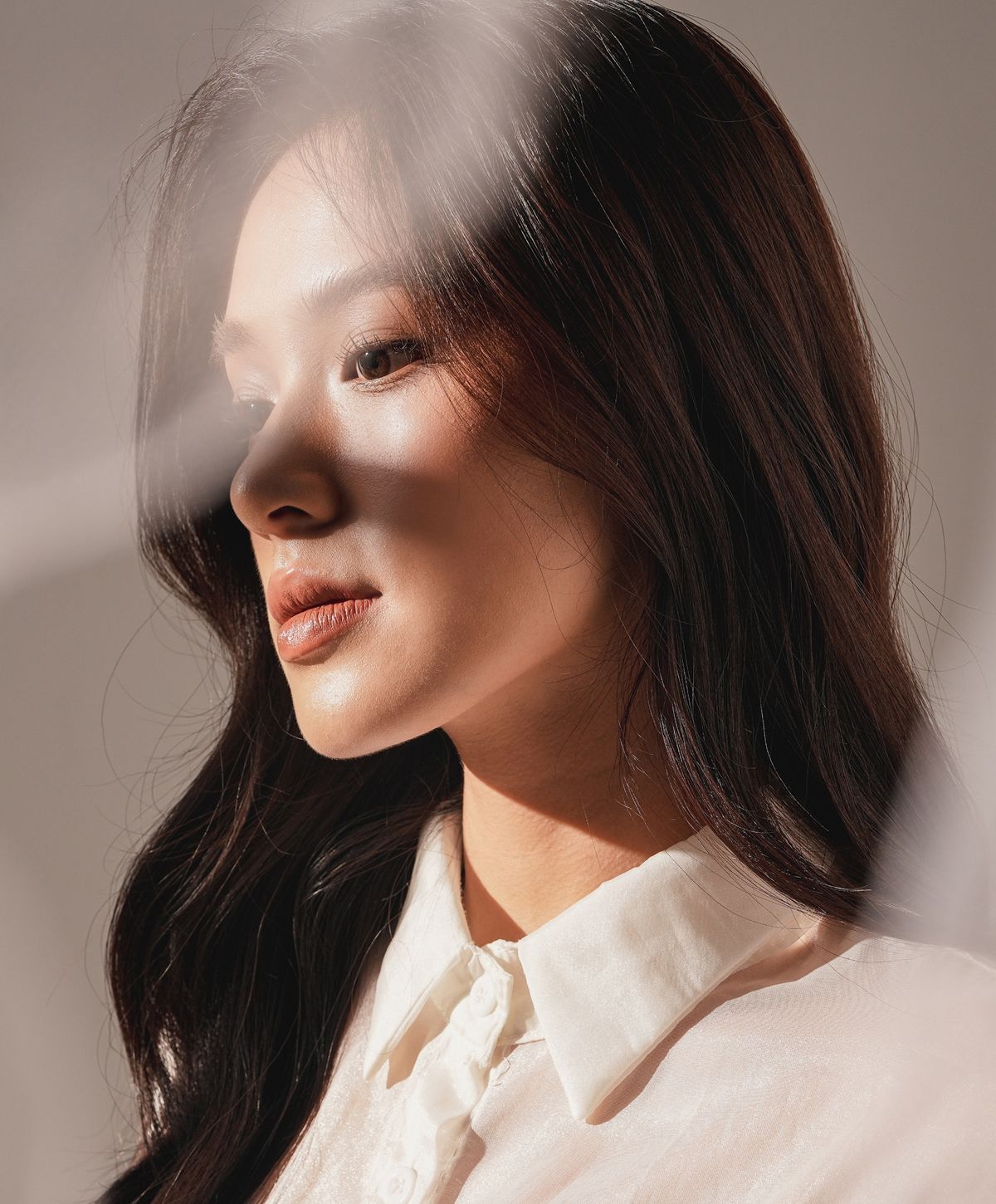 PRP treatment model with long curly hair wearing a sweater.