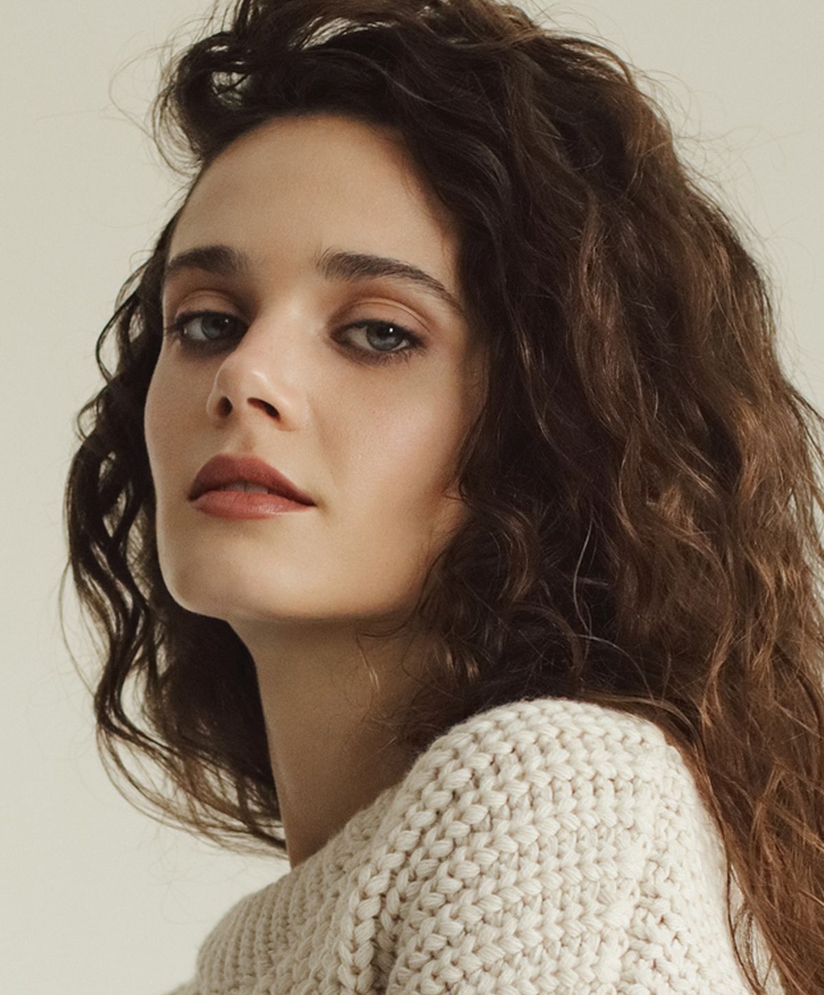 Young facials model with long brown hair and blue eyes.