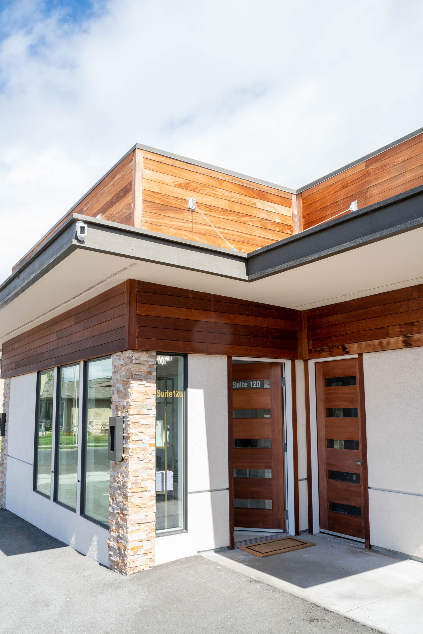 Modern commercial building entrance with wood accents.