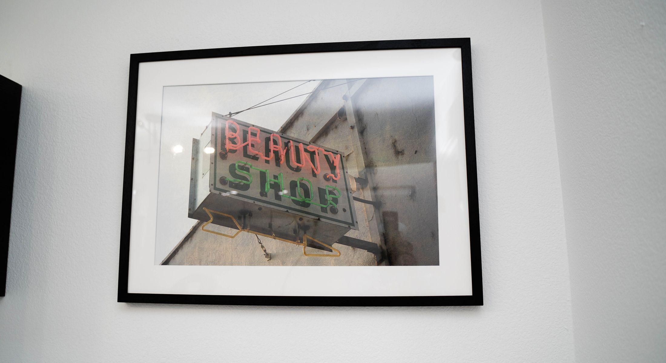 Framed beauty shop neon sign photograph.
