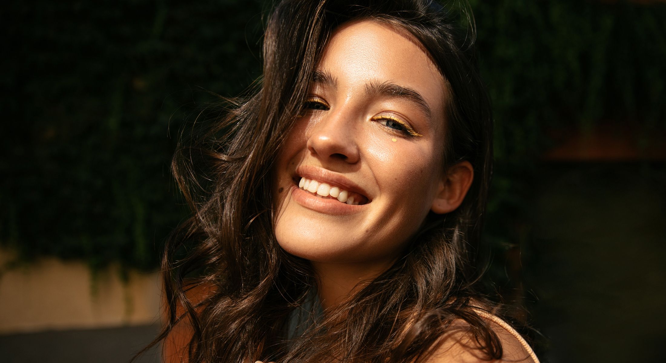 Smiling woman in stylish gray blazer.