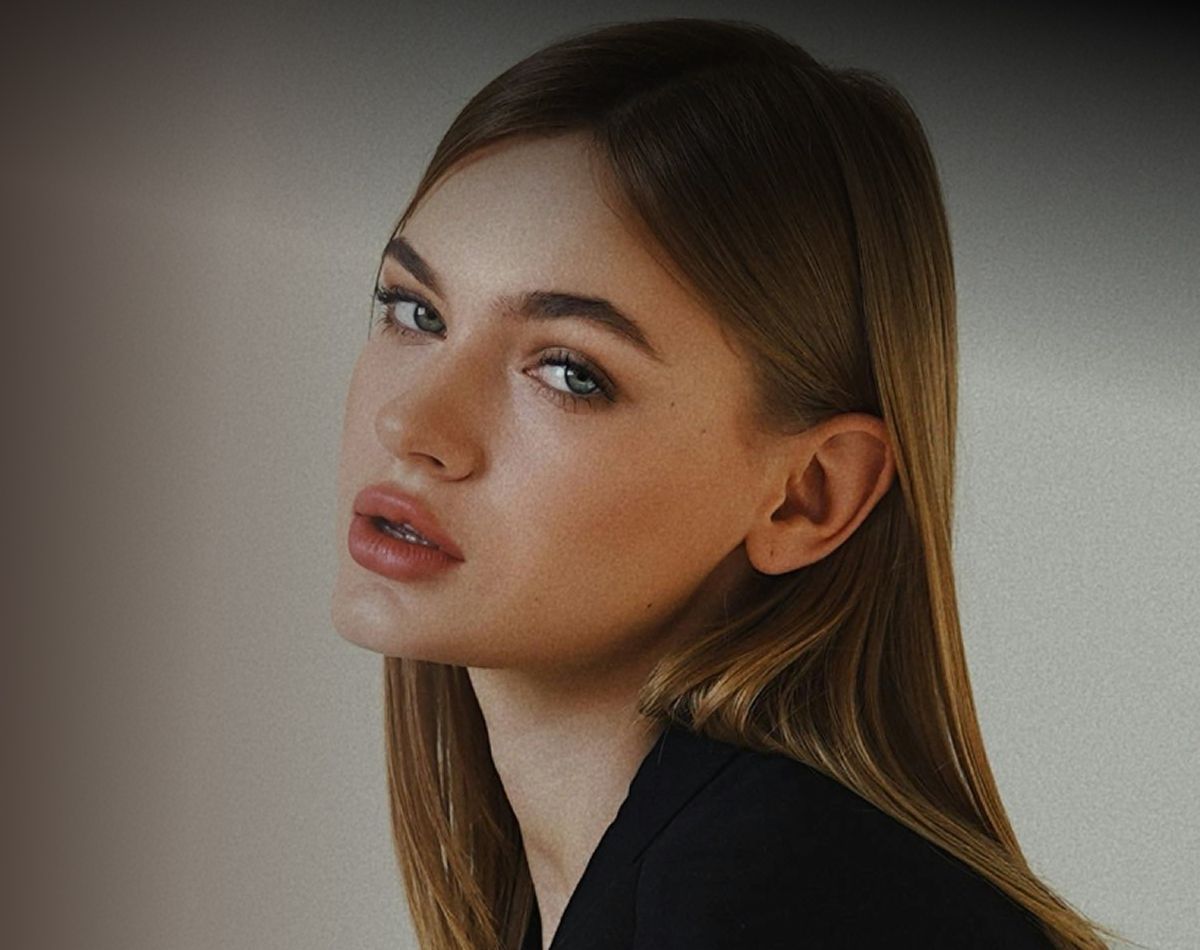 Santa Clara med spa model smiling softly in a natural setting.